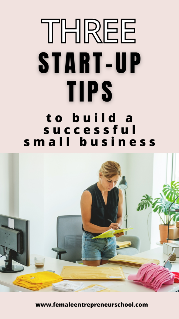 Pinnable image with the text Three Start up tips to build a successful small business, with an image of a woman in shorts standing at an office desk writing on paper.